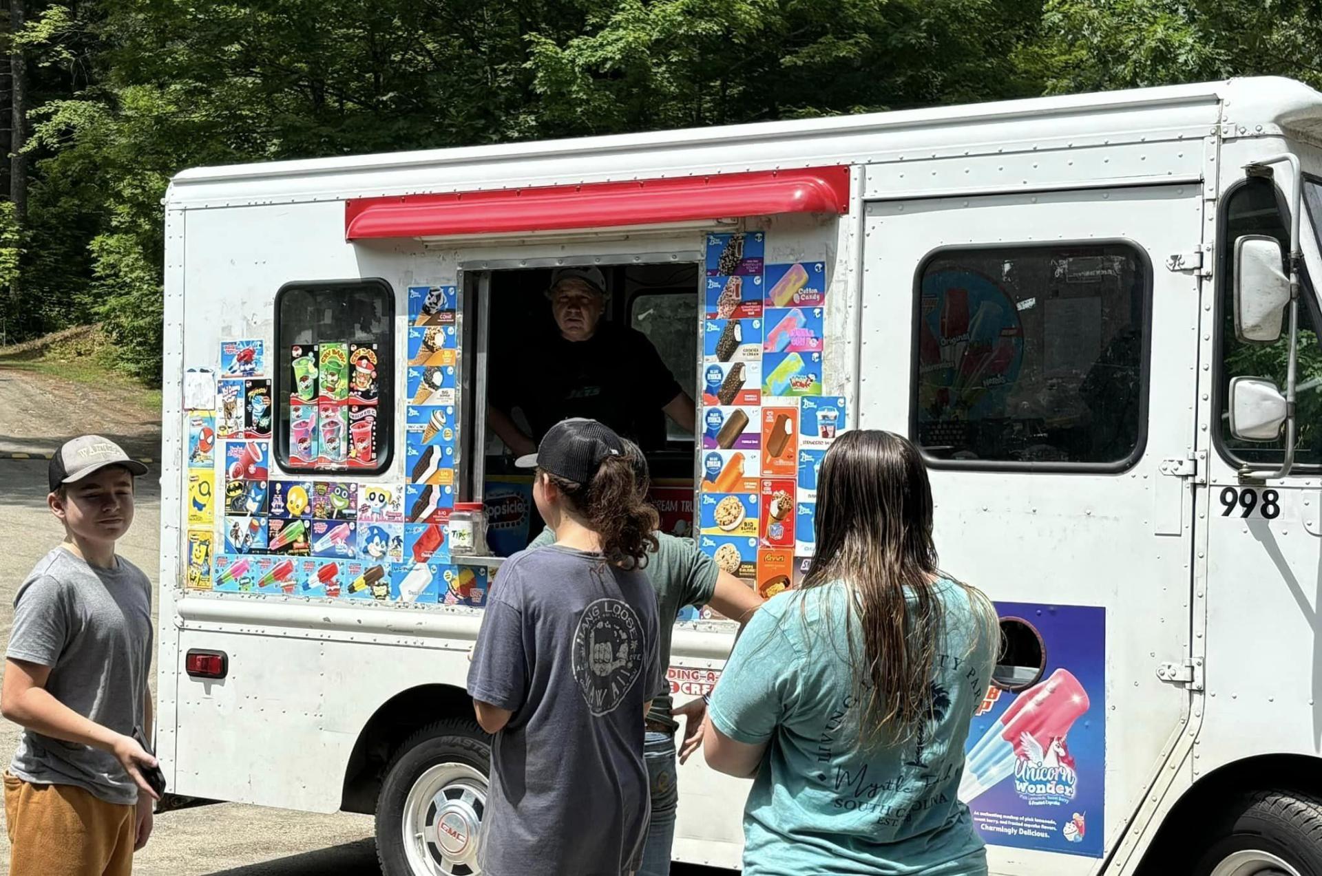 Kids enjoying a sweet treat from the ice cream truck