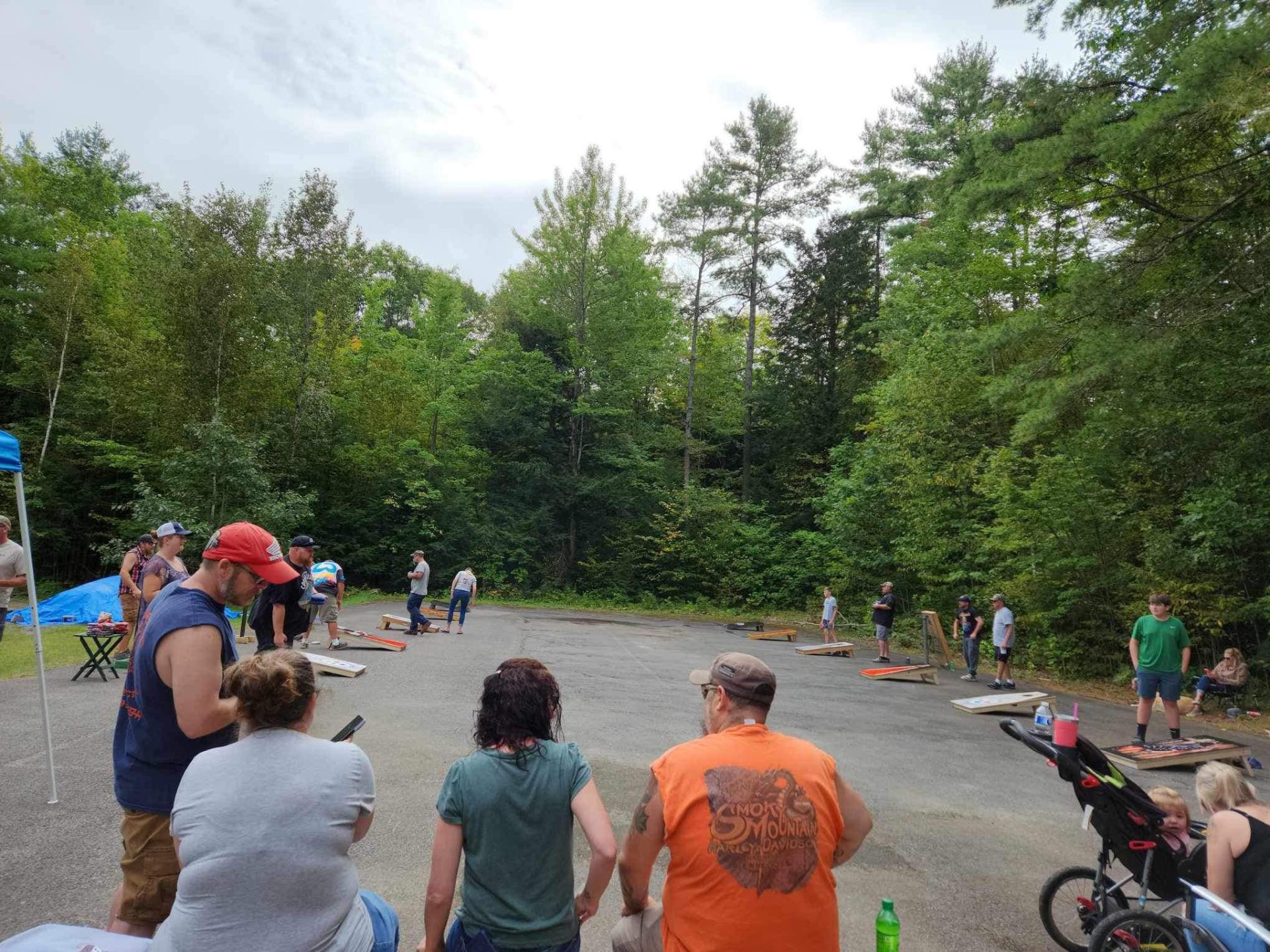5 teams playing corn hole
