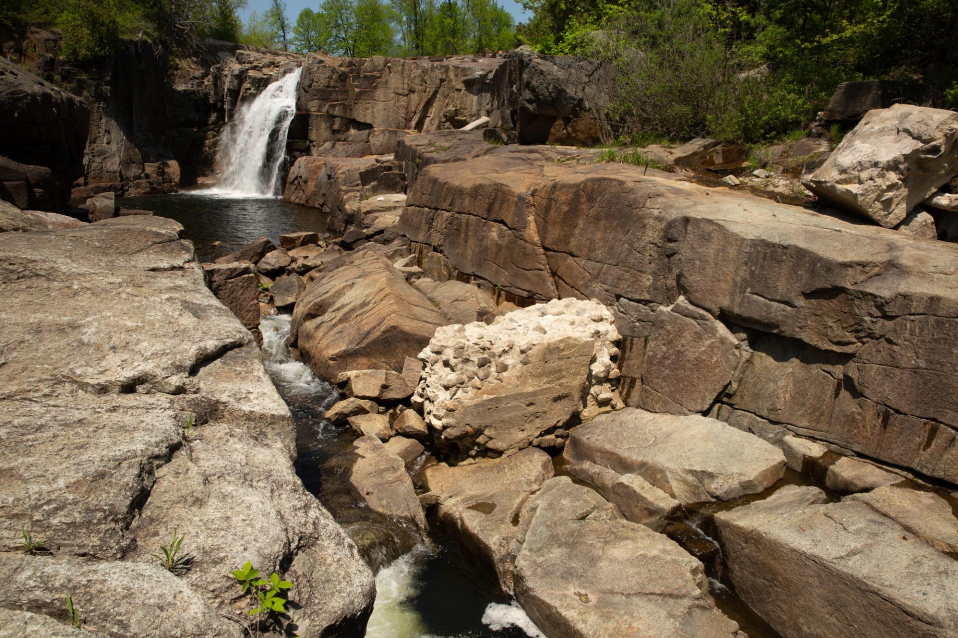 A single waterfall flowing into a pool of water