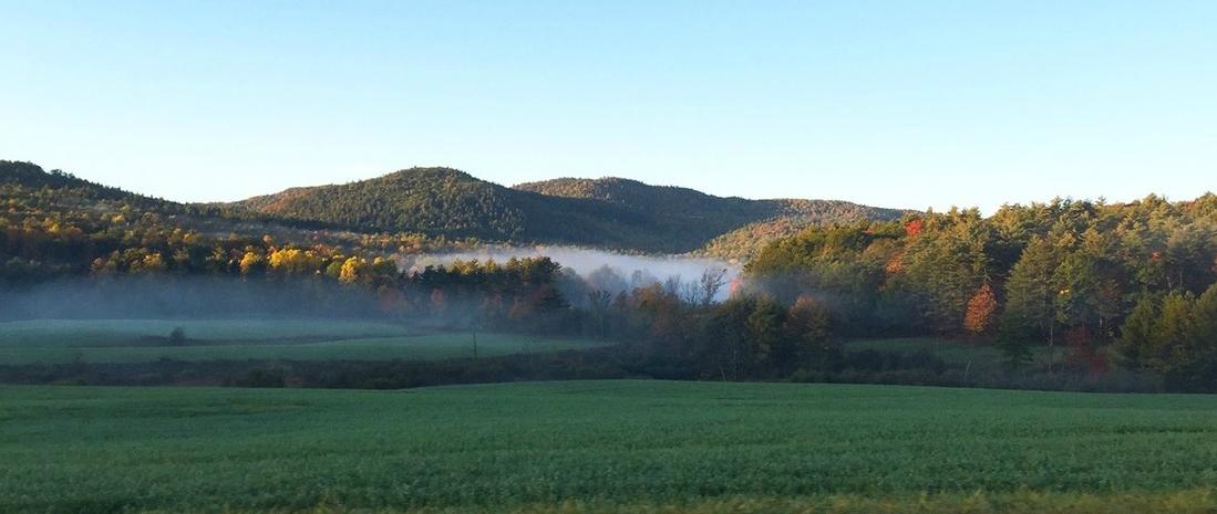 Roadside view of misty mountains