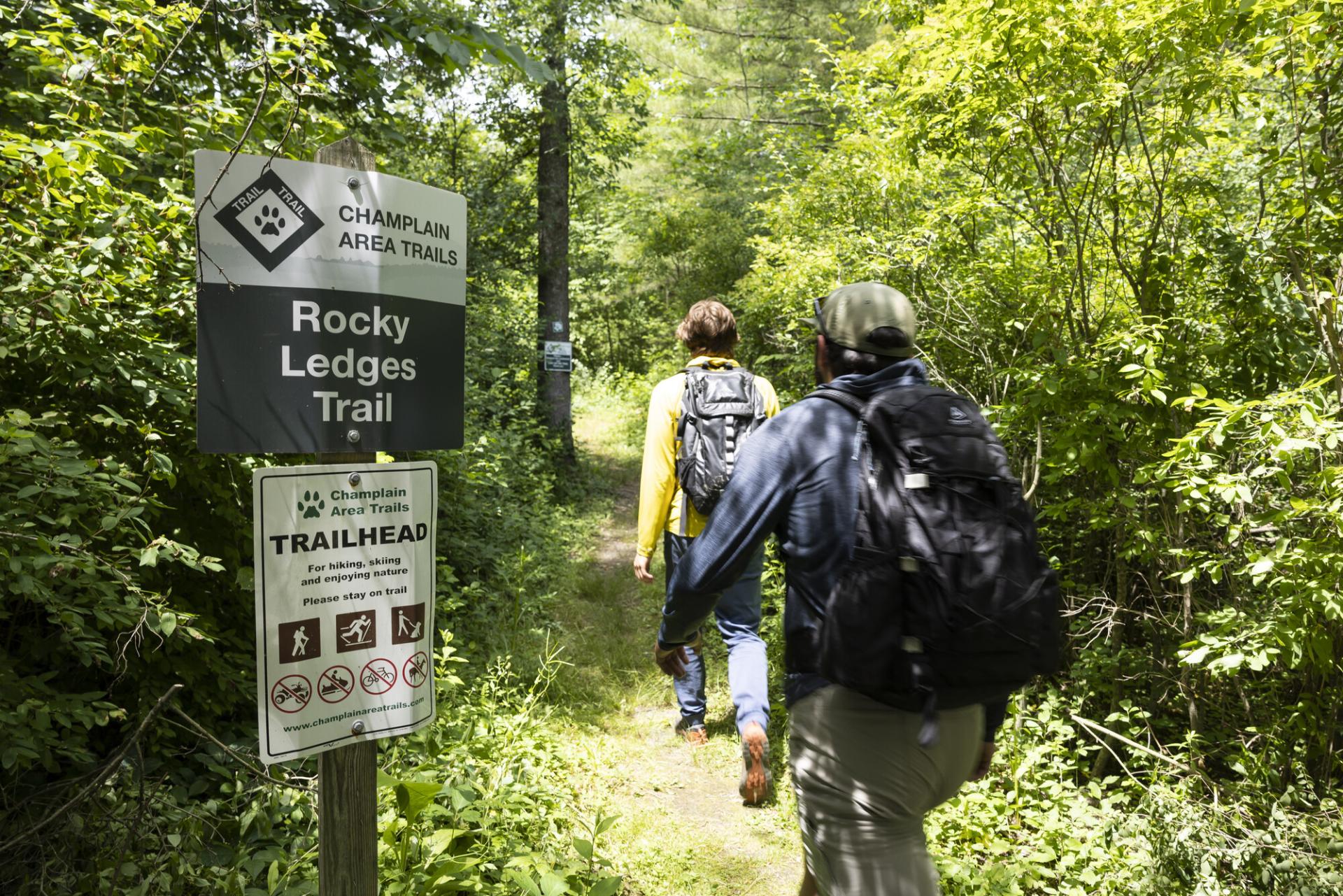 Two hikers head out onto the Rocky Ledges Trail.