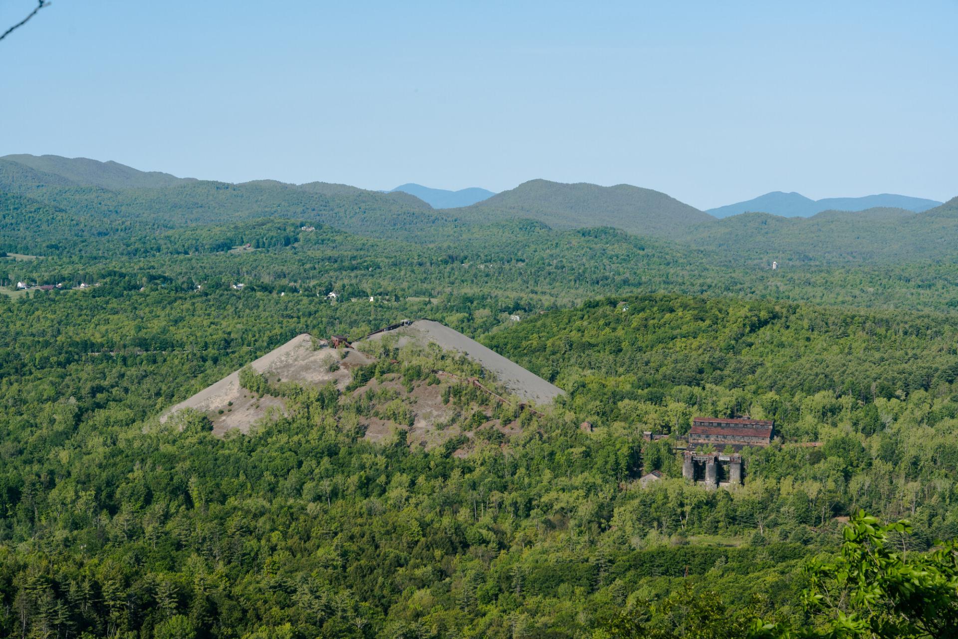 A large pile of mine tailings seen from a mountain