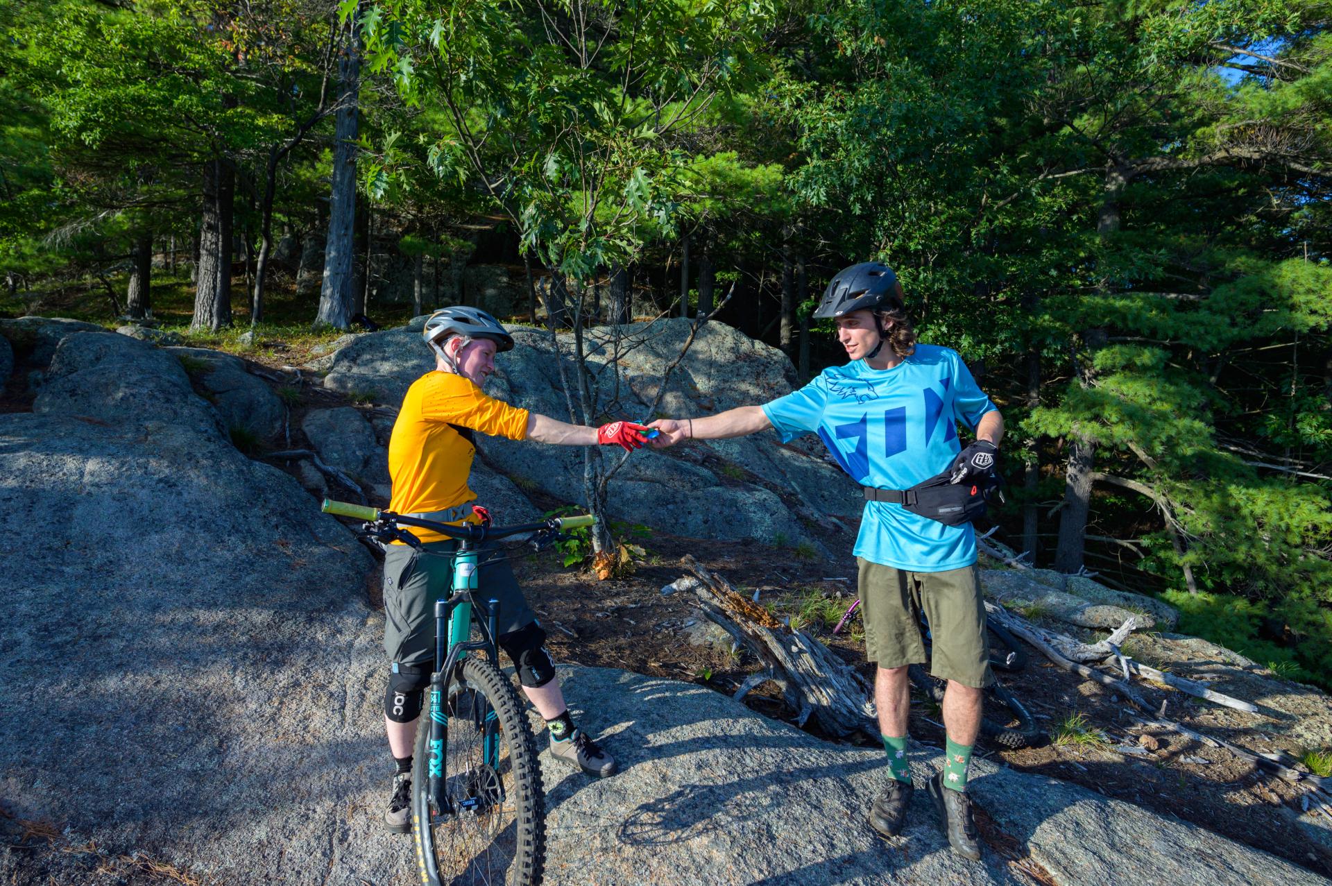 Two mountain bikers fist bump