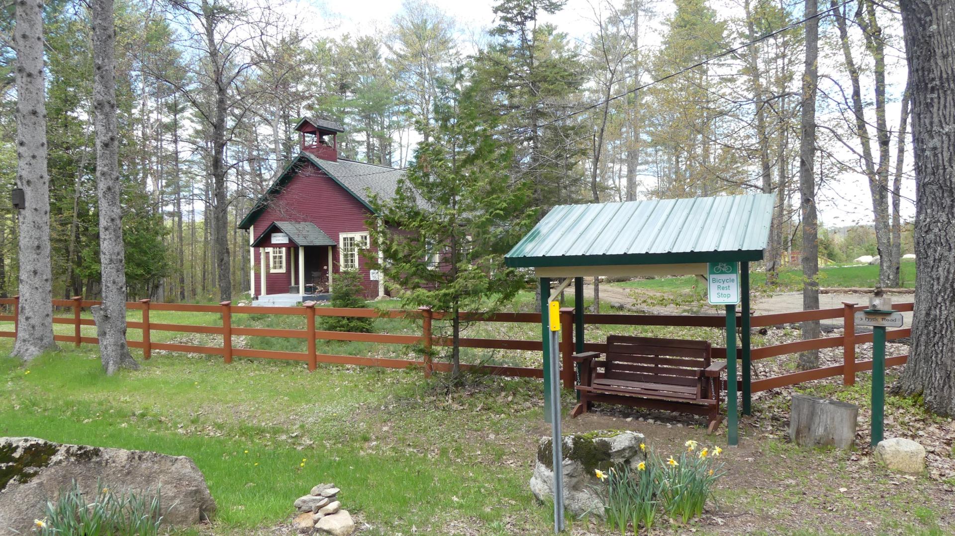 A small farm with red fence.