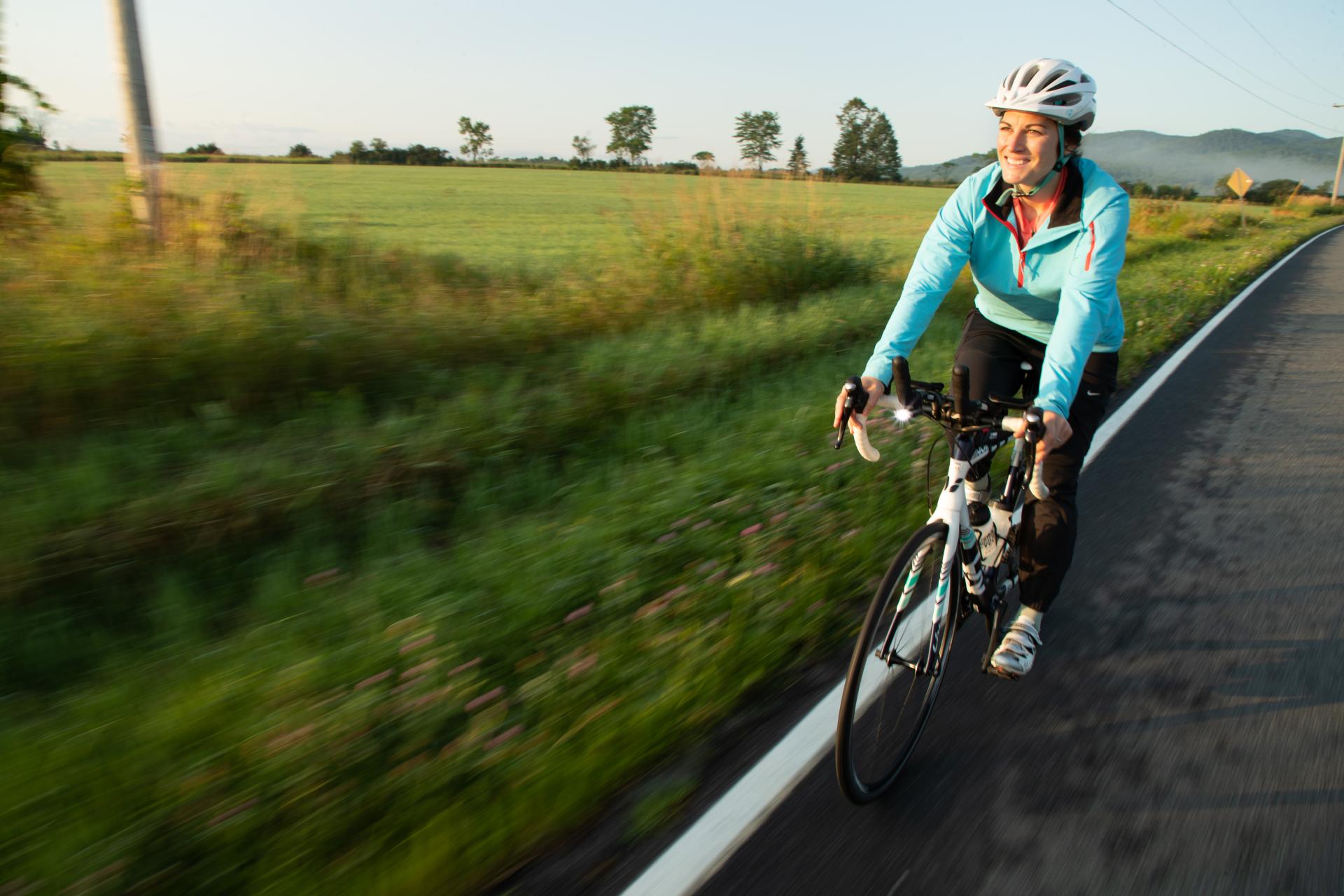 A woman cycling in the Lake Champlain Region.