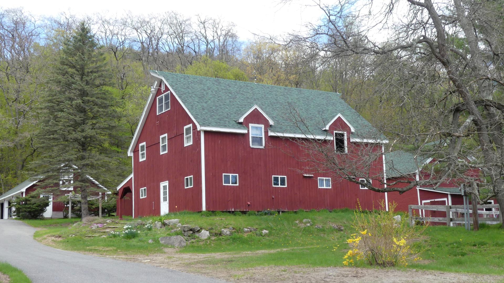 A red barn on the side of a cycling route.