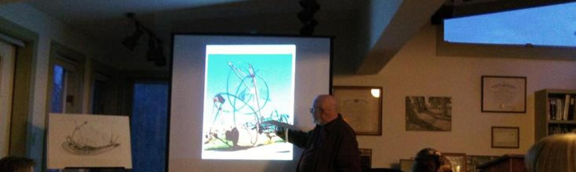 A man giving a presentation on sculptures