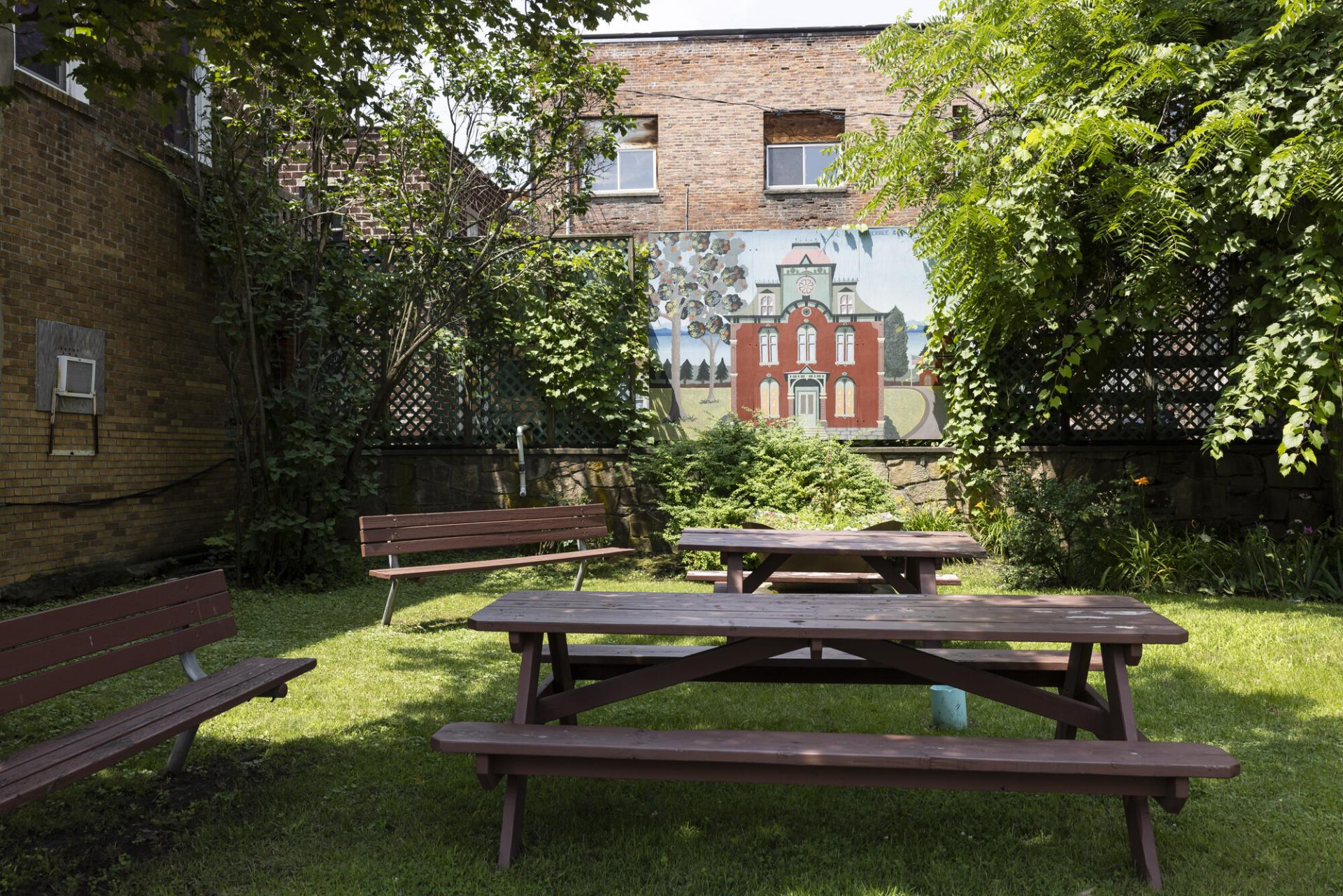 A mural at a small park with picnic tables