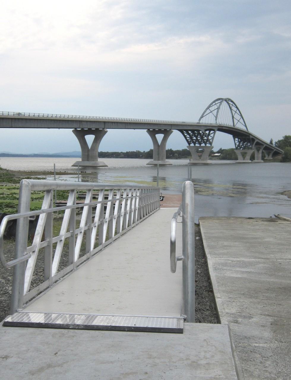 A boat launch in the shadow of a bridge