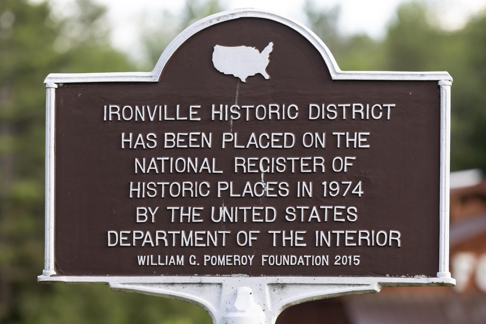 A brown metal historic sign for the Ironville Historic District