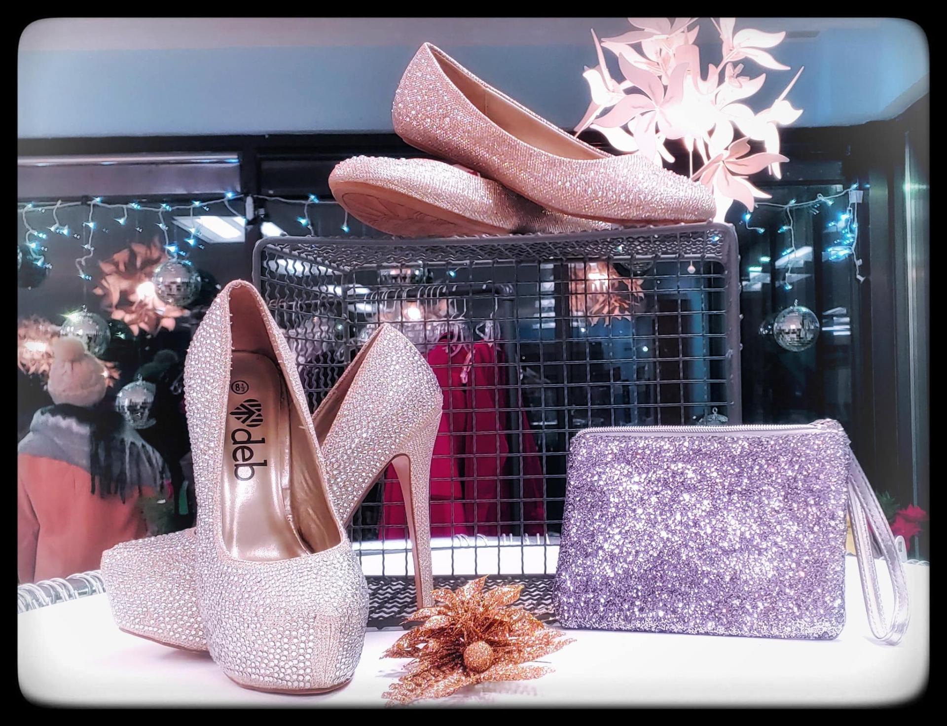 Shoes and purses in a display case.