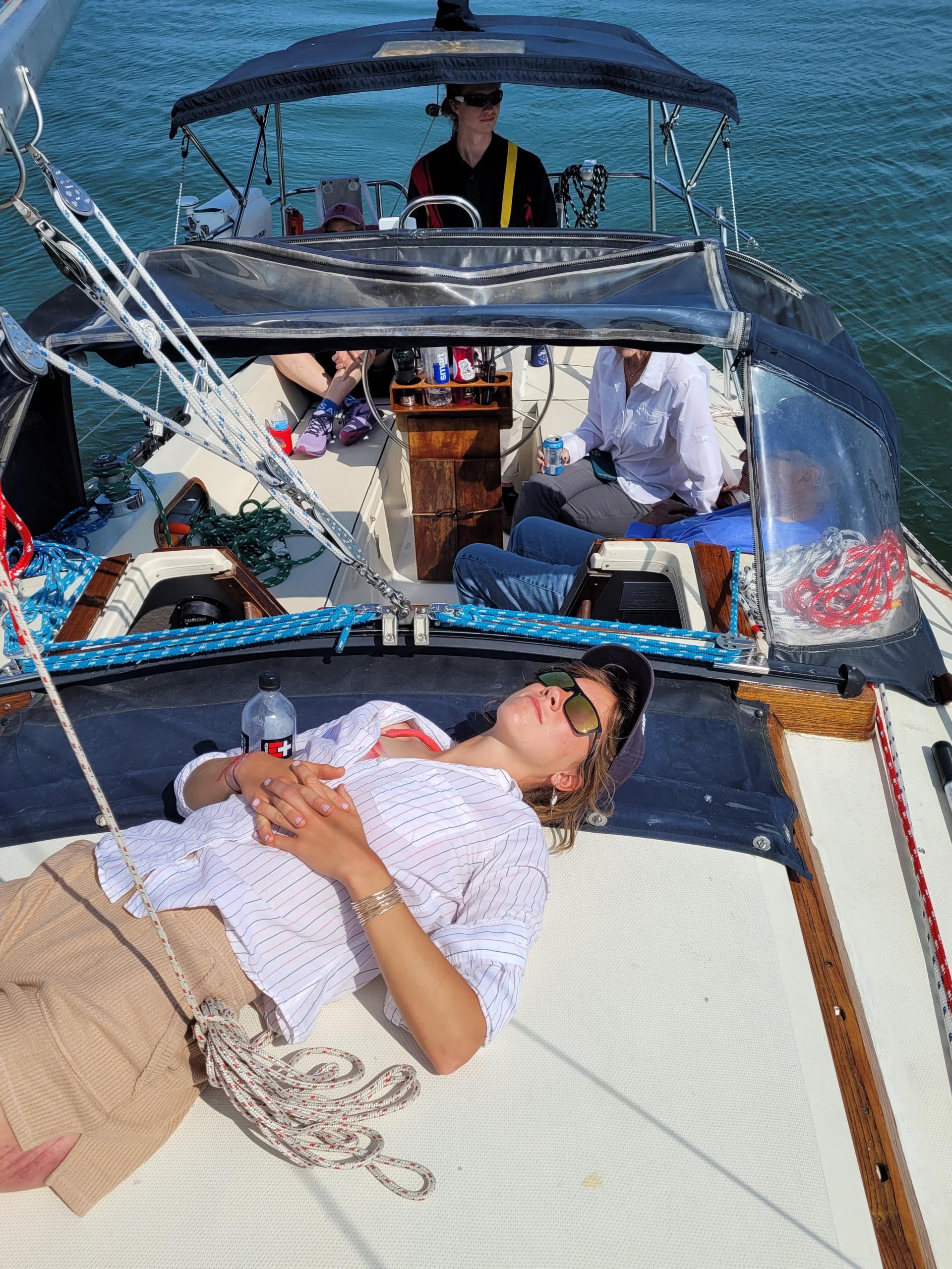 Person relaxing on sailboat