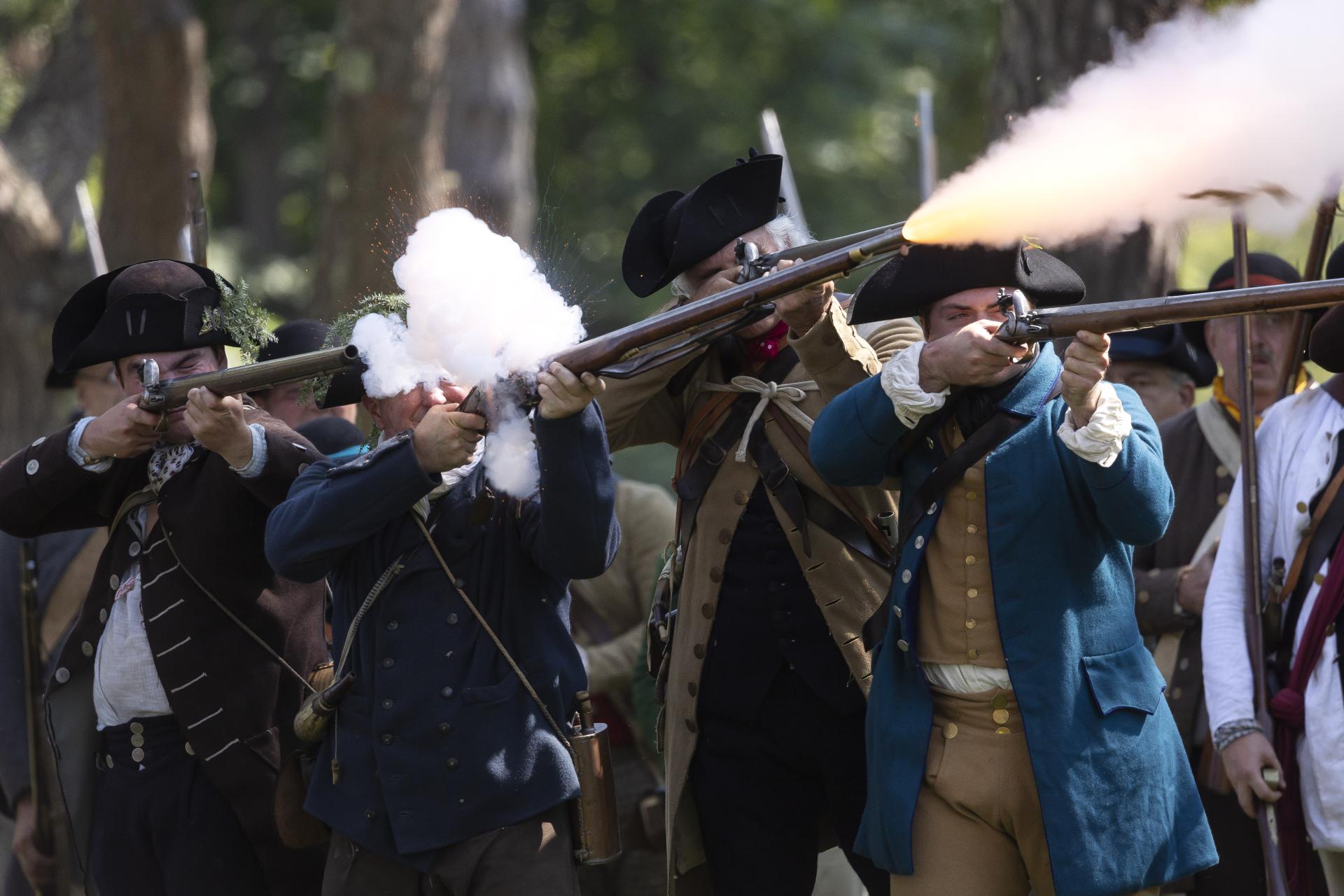 re-enactors firing guns at Fort Ticonderoga