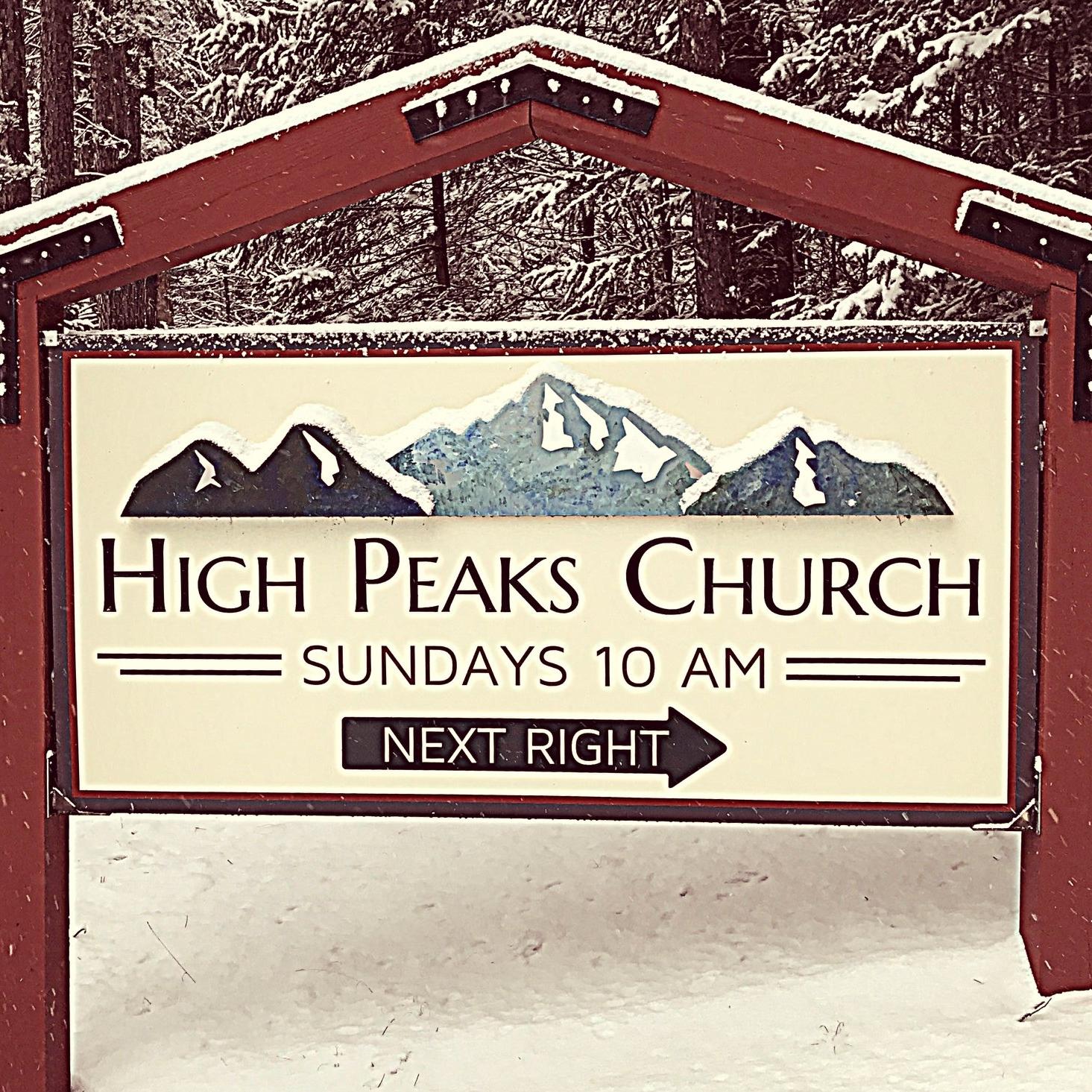 A sign for the entry to High Peaks Church blanketed in light snow