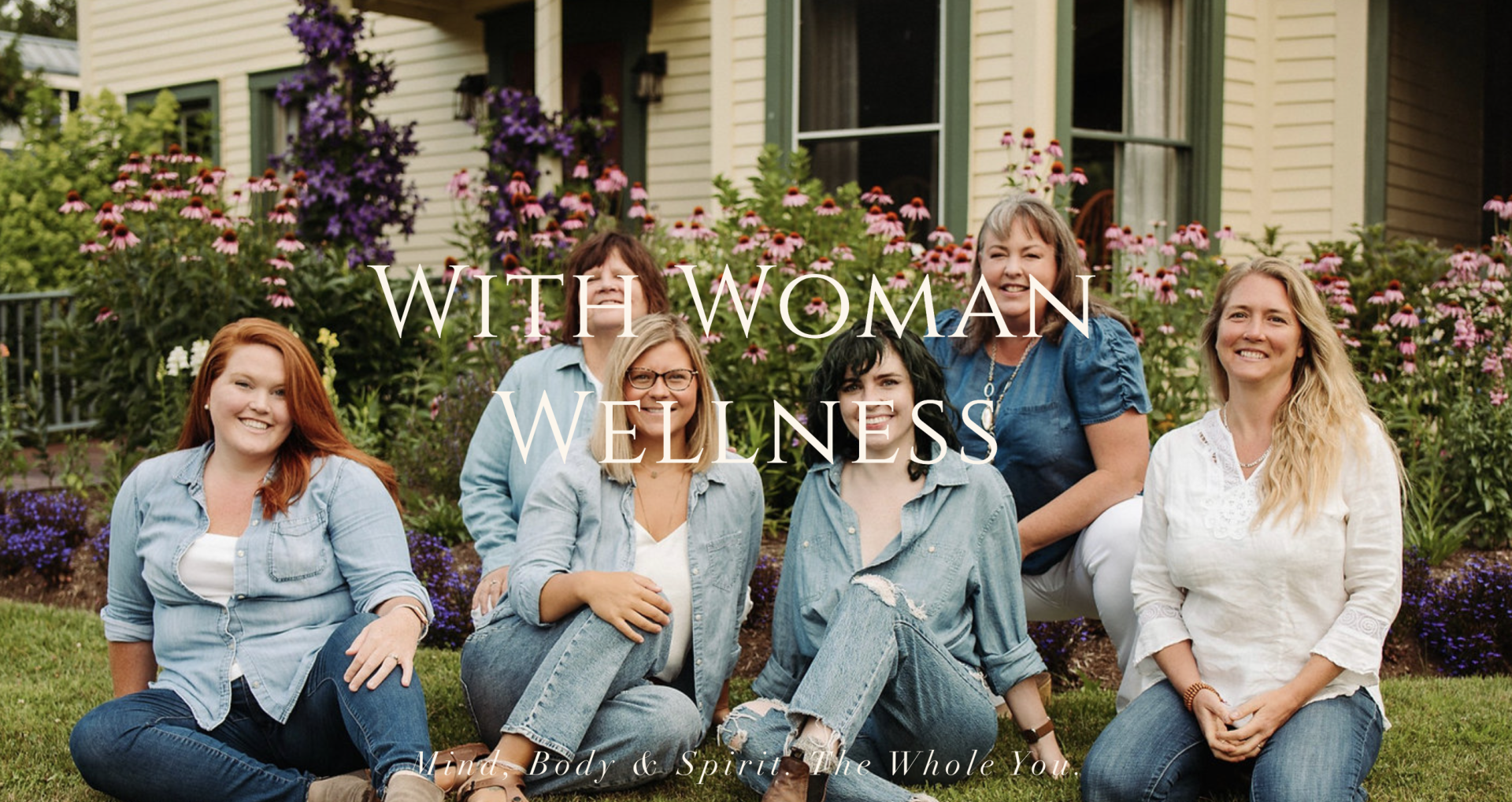 Women in matching outfits smile at the camera