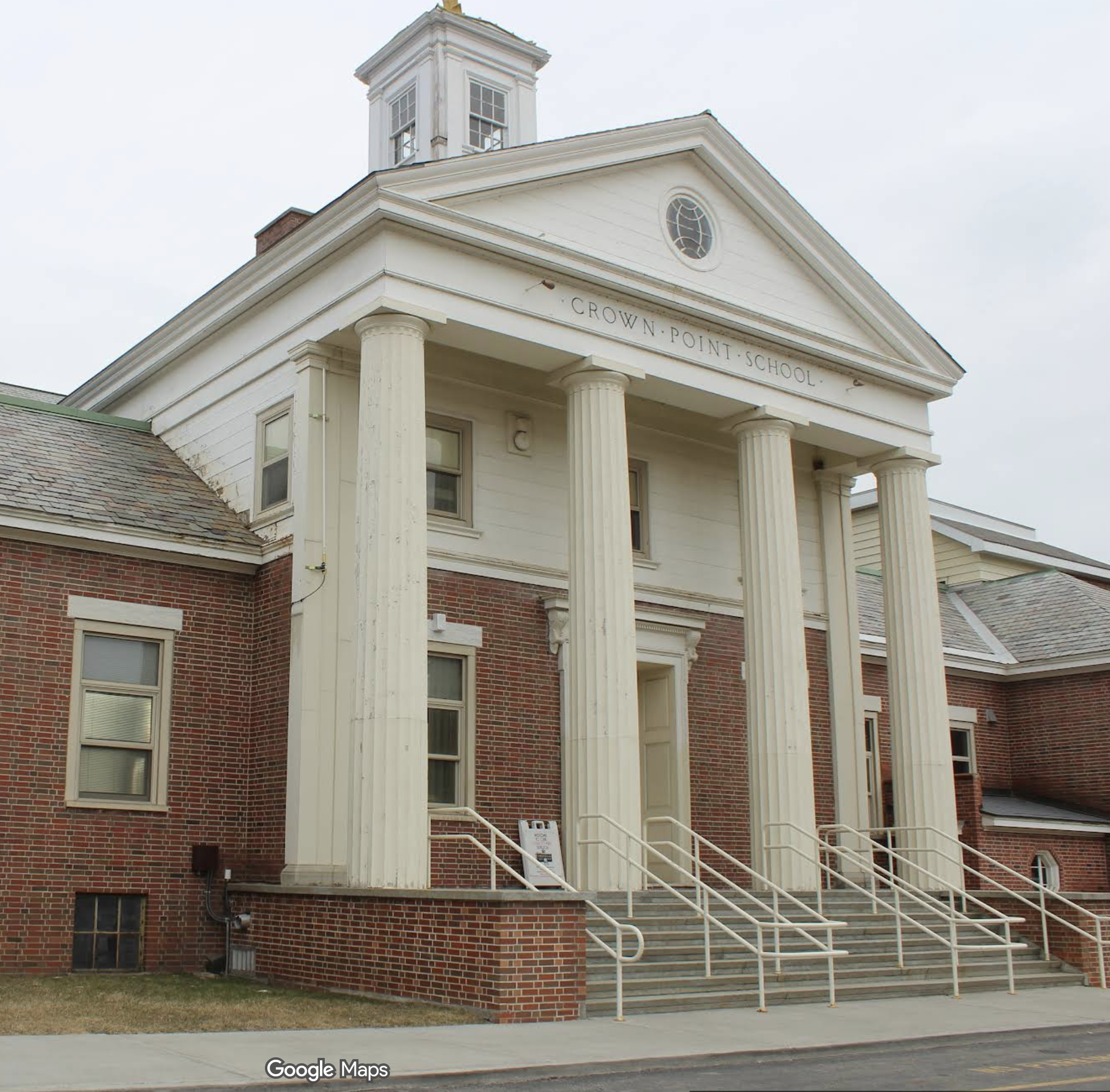 Tall white columns create a grand entry to the Crown Point School