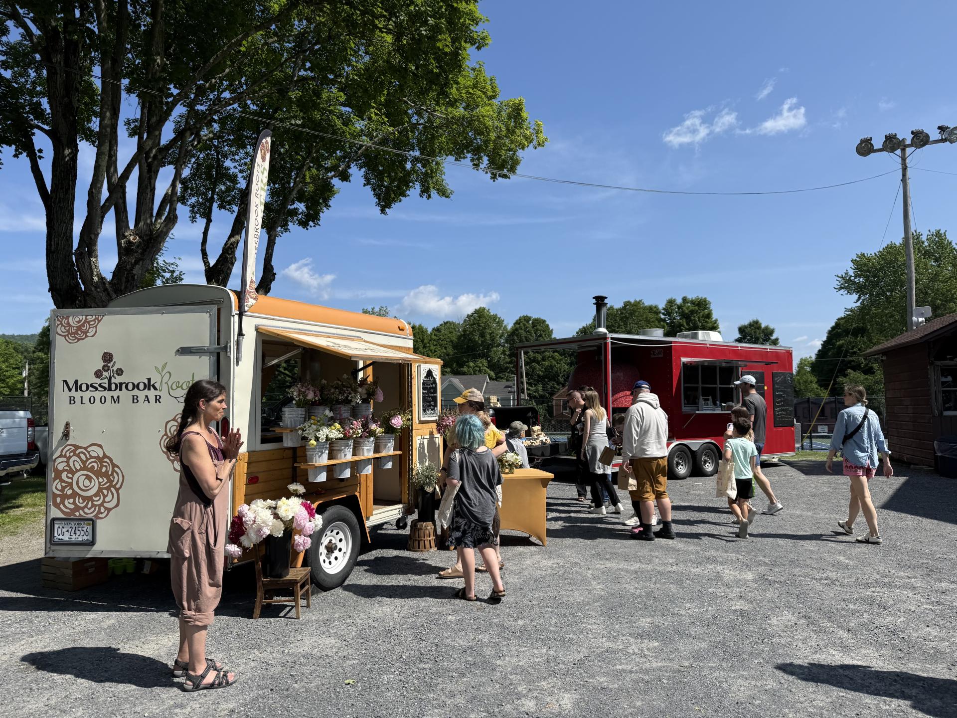  water bottles and kitchen utensils sit atop a yellow dresser in front of knotty pine walls