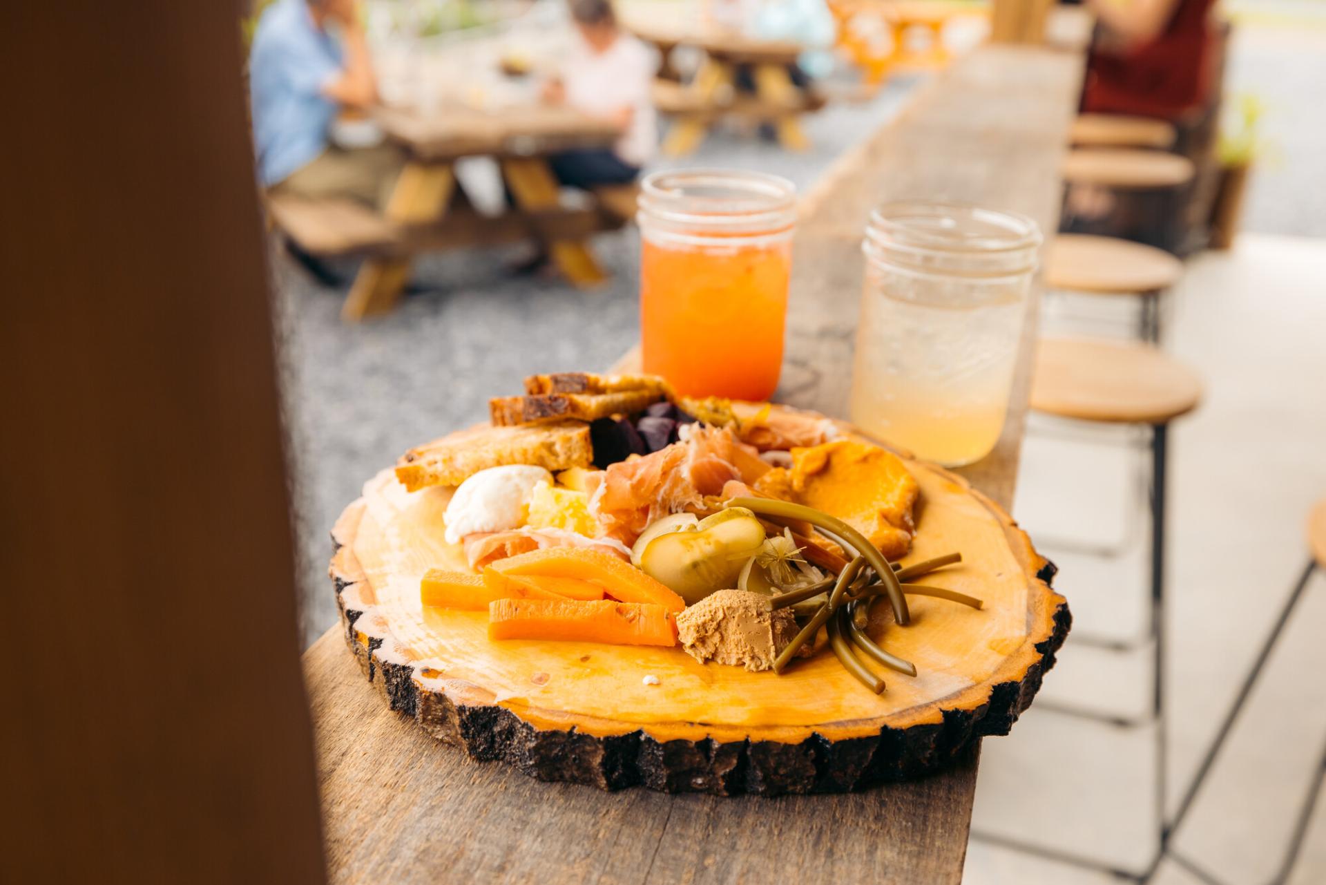 A wood plate of fresh produce.