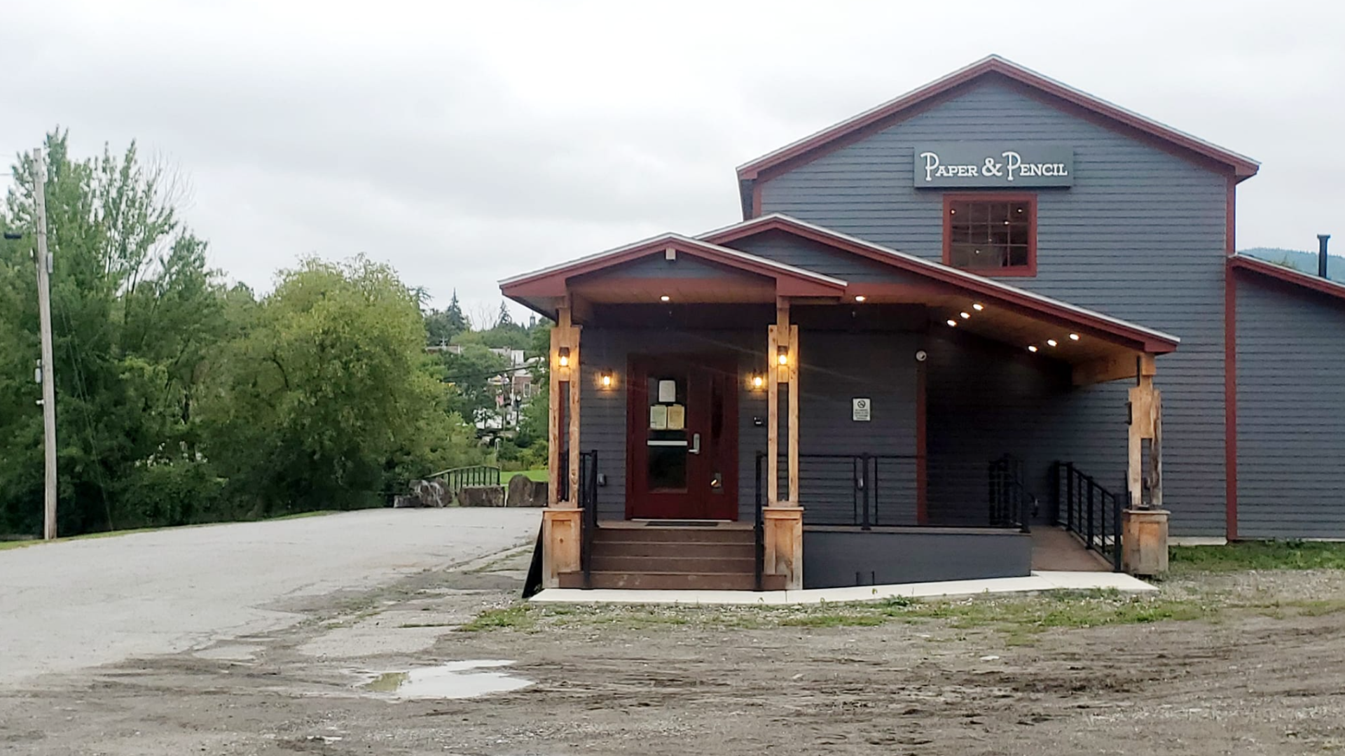 A blue building with a large covered entryway.