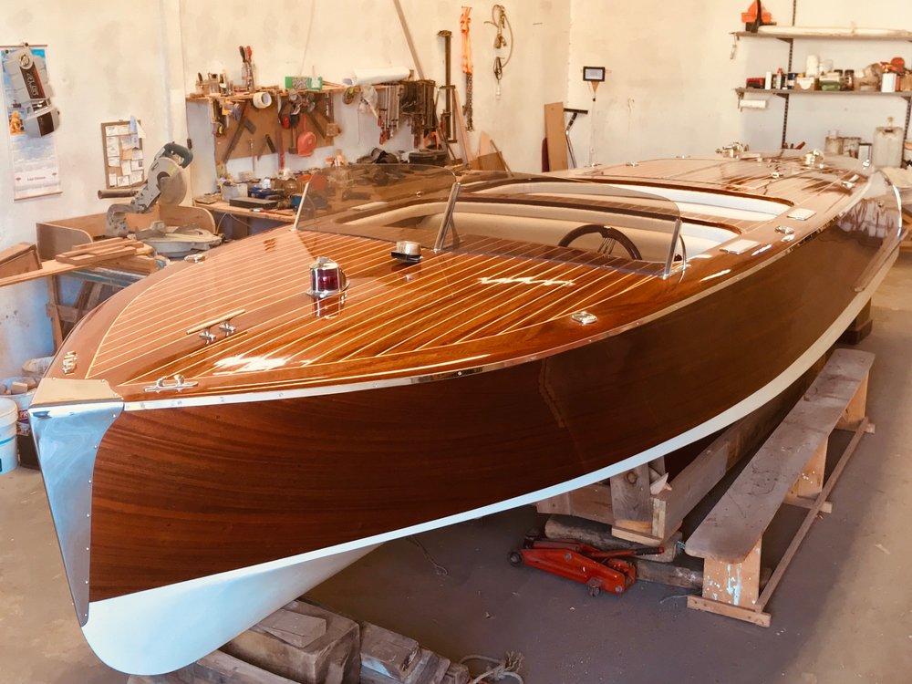 Finishing touches are put on the restoration of a beautiful wooden boat