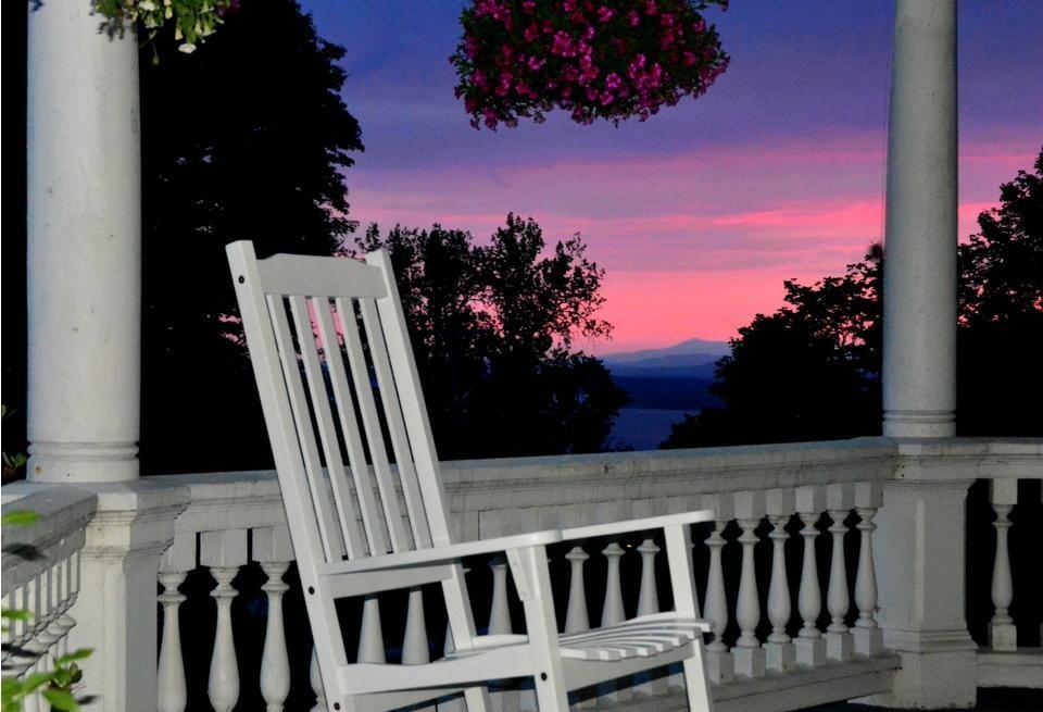 Pink & purple sun set from the white rocking chair on the covered porch.