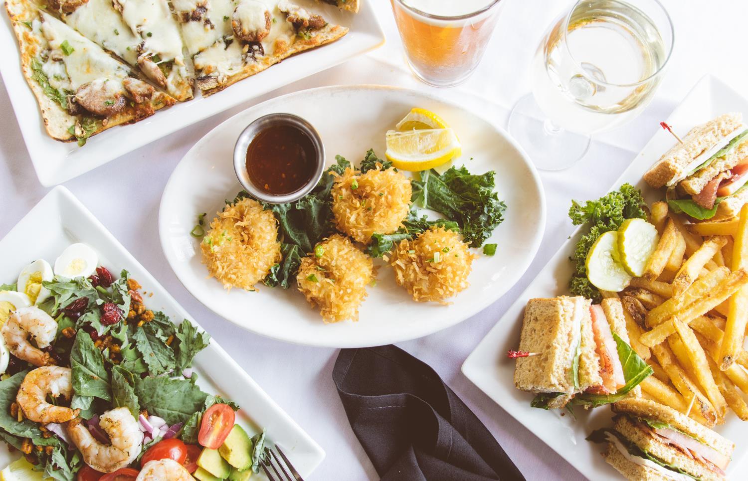 A variety of delicious meals on white plates at The Old Dock Restaurant.