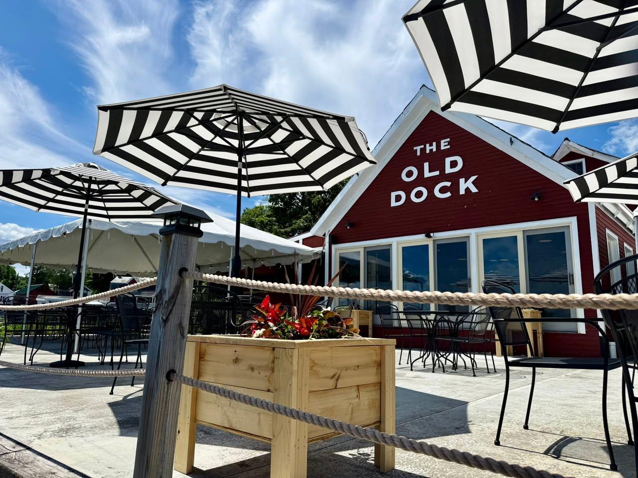 Black and white sun umbrellas on the roped off deck of The Old Dock Restaurant.