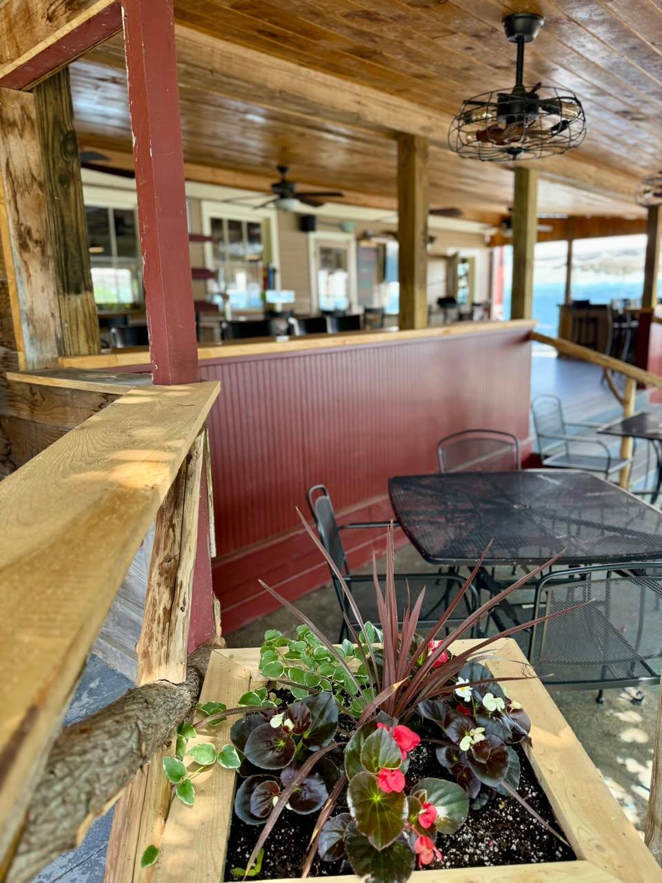 A long bar and seating area under a covered porch.