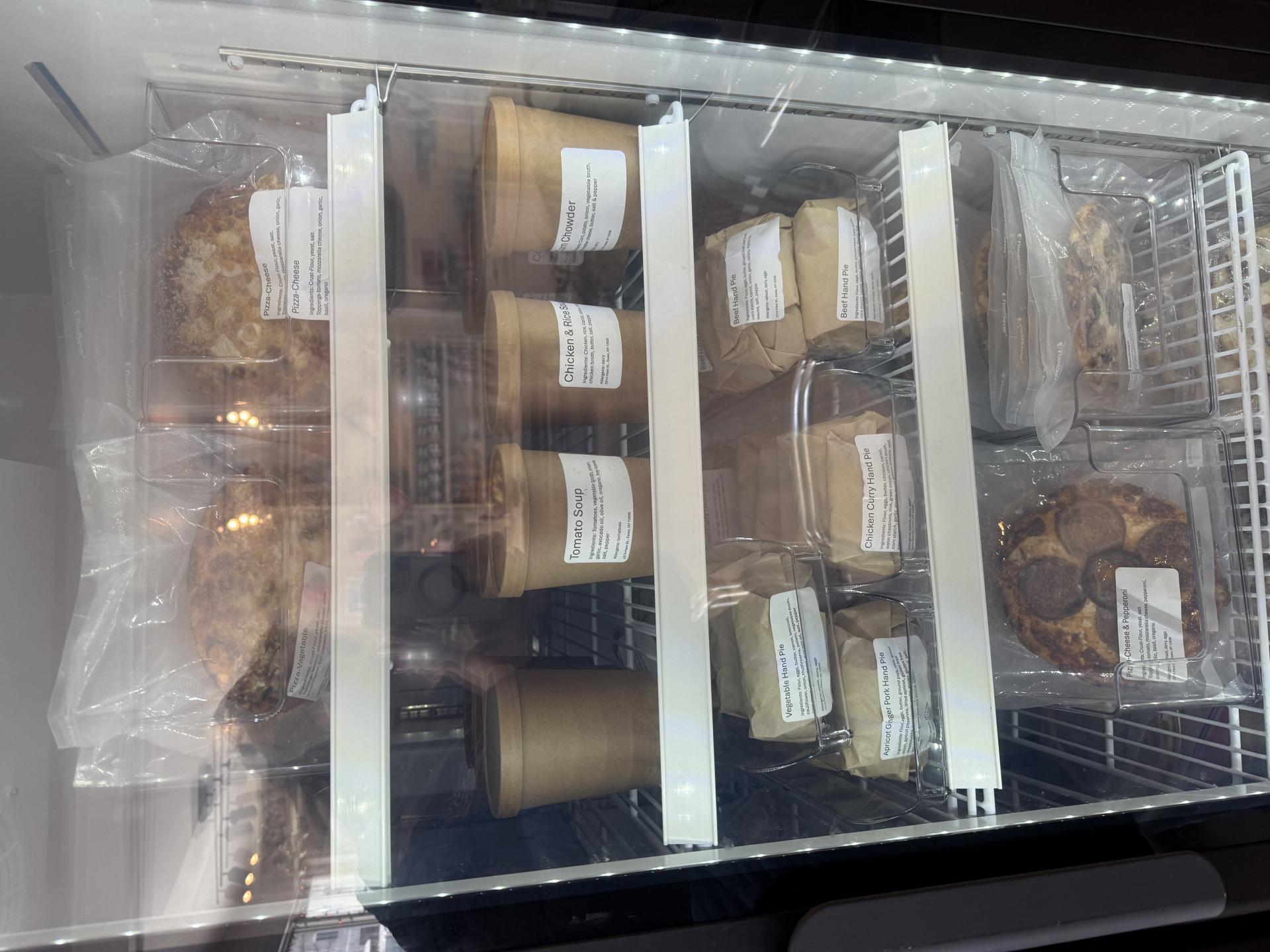 The dining space with freezer section and the stocked front counter at Essex Ice Cream Cafe.